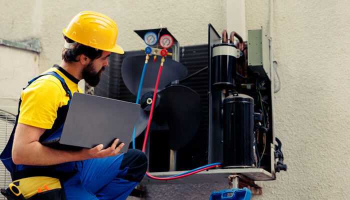 Poor air quality - tycoonstory | tycoonstory media An hvac technician is inspecting the cooling unit outside the kitchen, focusing on hvac issues its repair and maintenance to ensure proper operation