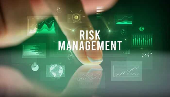 Risk management features - tycoonstory | tycoonstory media A person displaying risk management with data charts and graphs with a blue background, it represents strategies for managing risk using modern trading tools.