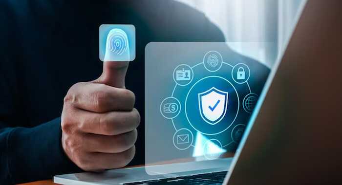 Secure authentication and authorization - tycoonstory | tycoonstory media User using fingerprint recognition for secure authentication and authorization on a laptop, illustrating app security features with a focus on privacy and protection.