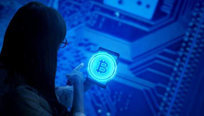 Software configuration - tycoonstory | tycoonstory media A woman pointing her fingure at a digital bitcoin symbol and with blue circuit background, represents bitcoin mining pool technology.