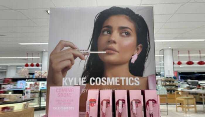The factors influencing kylie jenners wealth - tycoonstory | tycoonstory media Kylie cosmetics display in store showcasing products contributing to kylie jenner net worth