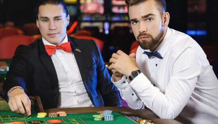 Avoid side bets - tycoonstory | tycoonstory media Two formal-garbed men at the casino table with roulette chips show the idea of playing baccarat online.