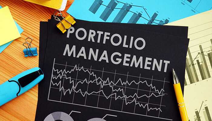 Balance your portfolio - tycoonstory | tycoonstory media Portfolio management documents with financial charts and graphs, along with office supplies, highlighting strategies for real estate portfolio and investment growth