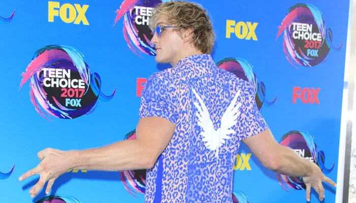 Boxing career - tycoonstory | tycoonstory media Logan paul at teen choice awards 2017 in vibrant blue shirt with wing design, posing playfully against a colorful fox backdrop, representing an energetic and bold style