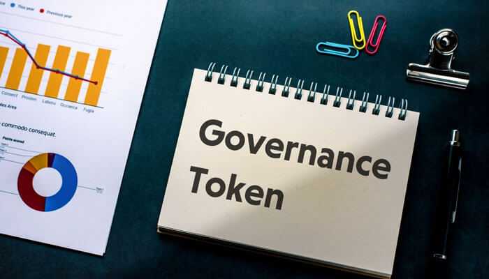 Challenges and criticisms- tycoonstory | tycoonstory media Governance token concept with a notebook displaying governance tokens alongside financial charts representing decentralized decision making and community participation in defi projects.