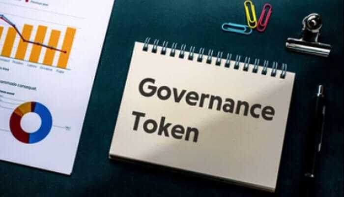 Notebook labelled Governance Tokens, lying on a desk with a chart, coloured paper clips, and a pen.