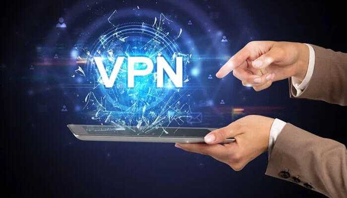 Choosing the right vpn for kodi - tycoonstory | tycoonstory media Person using a tablet with a holographic vpn symbol, illustrating how a can vpn improve your kodi experience securely.