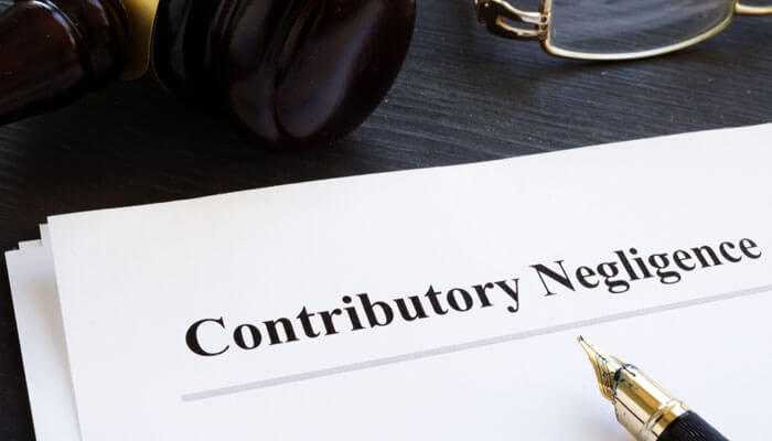 Legal document titled Contributory Negligence with a gavel and pen, symbolizing the challenges in proving medical malpractice cases