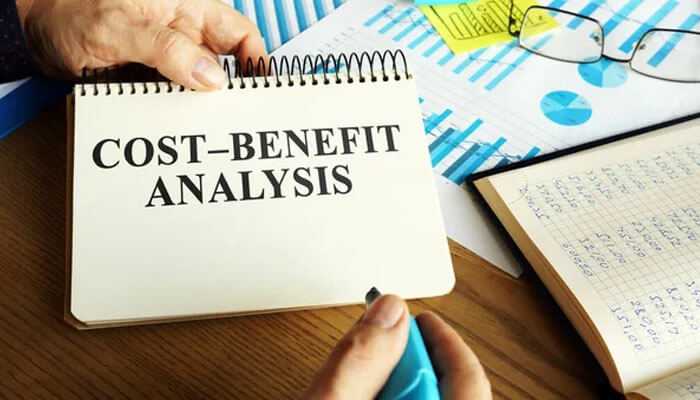 Cost-benefit analysis - tycoonstory | tycoonstory media A cost-benefit analysis notebook open on a desk, reflecting the process of evaluating bamboohr pricing and its impact on business efficiency and budgeting.