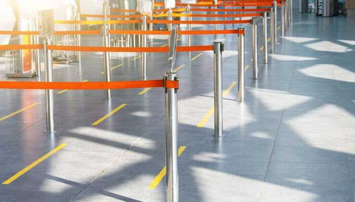Crowd management - tycoonstory | tycoonstory media Retractable barriers set up to organize foot traffic in a public area, creating orderly queues and guiding movement for crowd control and safety