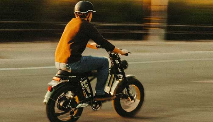 Customize your ride - tycoonstory | tycoonstory media Person riding an electric bike on a sunny day, showcasing stylish electric bikes, comfortable commute ideal for urban living and sustainable transportation