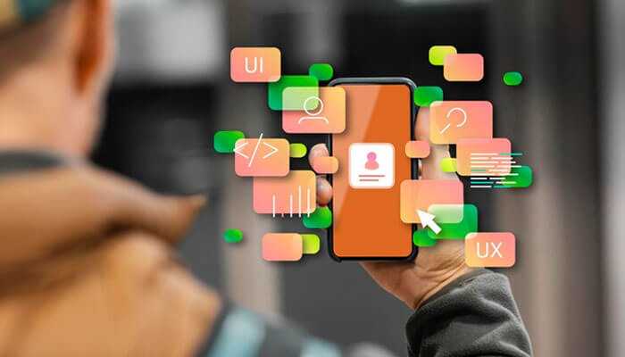 Enhancing usability - tycoonstory | tycoonstory media Person holding a smartphone with floating ui and ux icons, symbolizing user-centric design and the importance of user experience in product development