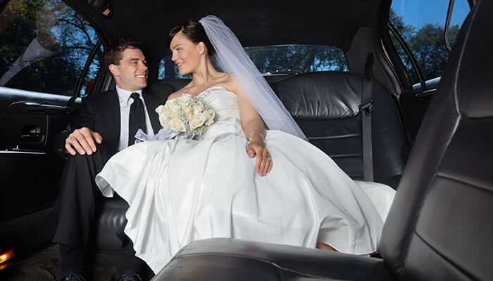 How a wedding limo enhances your day - tycoonstory | tycoonstory media Bride and groom enjoying a luxurious limo wedding service in chicago