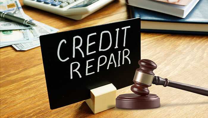 How credit repair and real estate law intersect -tycoonstopry | tycoonstory media Credit repair and real estate lawyers with credit repair sign and gavel on a desk, symbolizing the legal aspects of building a strong financial foundation and improvement