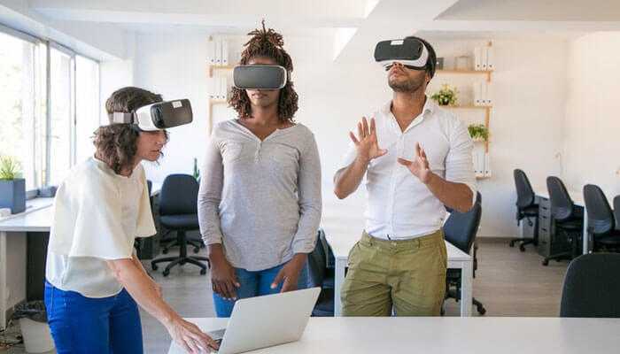 Increased motivation and productivity - tycoonstory | tycoonstory media Three people in an office wearing vr headsets for immersive learning for remote employees.