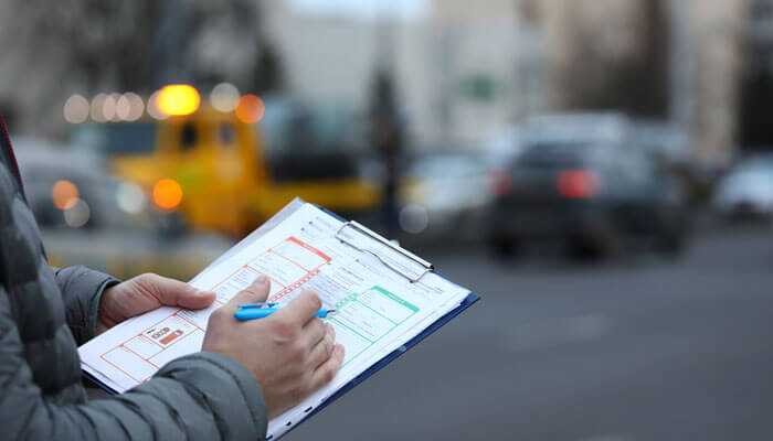 Key elements of a police report - tycoonstory | tycoonstory media Officer documenting a police report after an accident, ensuring accurate records and compliance for insurance and legal purposes