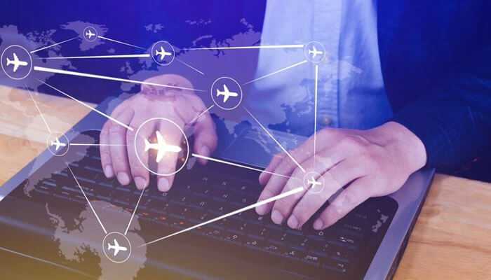 Leveraging cloud for collaborative aerospace rd and production - tycoonstory | tycoonstory media Aircraft networking technologies concept showing a global aviation network mapped over a laptop interface for real-time aircraft connectivity and data exchange.