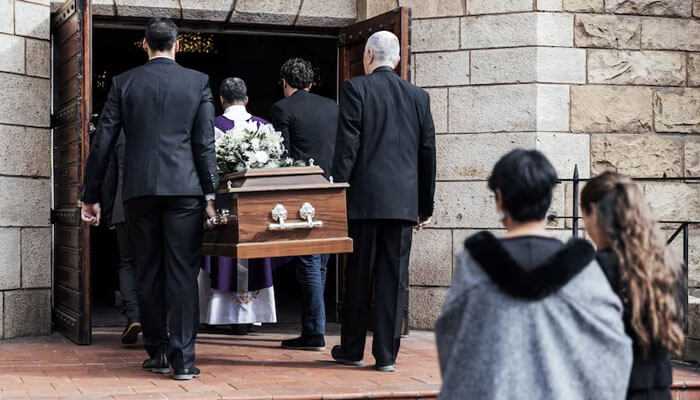 Local service providers - tycoonstory | tycoonstory media Pallbearers carry a casket into a church, with mourners at its rear. Affordable cremation services provide a respectful alternative.
