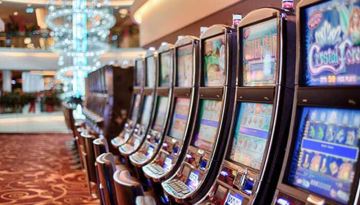 Maintain in-play betting at your pulse - tycoonstory | tycoonstory media Row of slot machines in a casino, illustrating opportunities for winning big prizes in online football betting through strategic gameplay