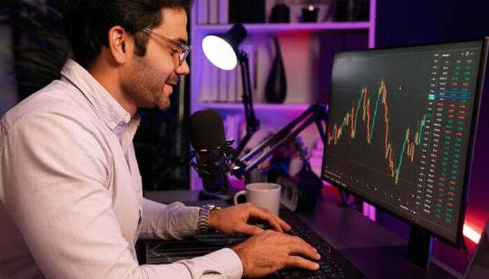 Metatrader 4 for pc - tycoonstory | tycoonstory media Trader analyzing financial market data on a monitor, engaged in copy trading to leverage insights from experienced investors and optimize portfolio performance
