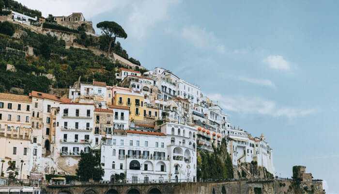 Paid search ads - tycoonstory | tycoonstory media Native advertising scenic view of colorful hillside buildings on the amalfi coast italy with a clear blue sky in the background
