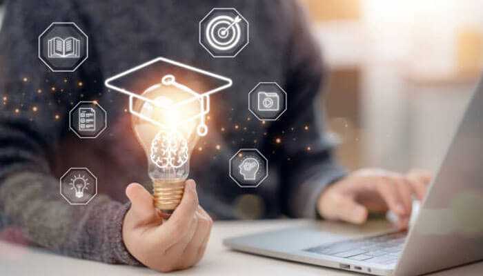 Personal growth and learning opportunities - tycoonstory | tycoonstory media Person holding a light bulb with educational icons, representing the journey of pursuing an advanced degree.