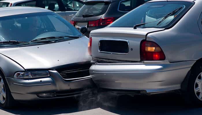 The legal ramifications of car accidents in parking lots - tycoonstory | tycoonstory media A rear-end collision between two silver cars, illustrating the concept of liability in personal injuries