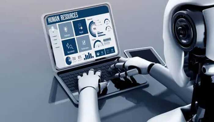 The role of predictive analytics - tycoonstory | tycoonstory media Ai-powered robot typing on a laptop displaying human resources analytics, symbolizing the use of ai in hiring processes.