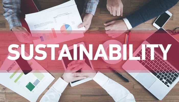 The role of sustainability in modern business - tycoonstory | tycoonstory media Team working on sustainability strategies with documents and charts highlighting the sustainable business social impact agency.