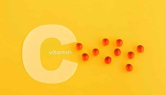 Vitamin c the immune and energy booster - tycoonstory | tycoonstory media Creative expression of vitamins to boost energy, orange capsules cascading from a large letter'C' on a yellow background.