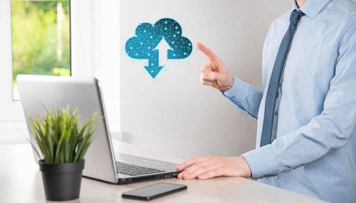 Why migrate your data to the cloud - tycoonstory | tycoonstory media A person interacting with a cloud icon above a laptop, symbolizing cloud-based bookkeeping services in san antonio.