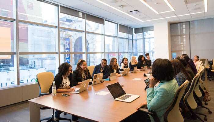 Boosting engagement and performance - tycoonstory | tycoonstory media A diverse group of professionals in a modern office, representing gamification in corporate teams.