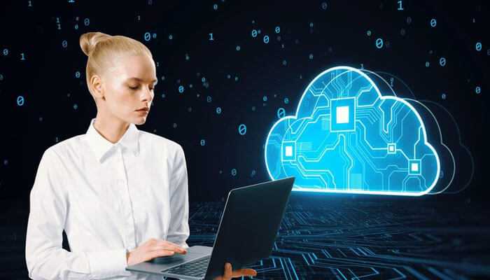 Cloud computing specialists leading the charge - tycoonstory | tycoonstory media Businesswoman using a laptop against the background of a digital cloud icon; it means cloud computing, computer science careers.