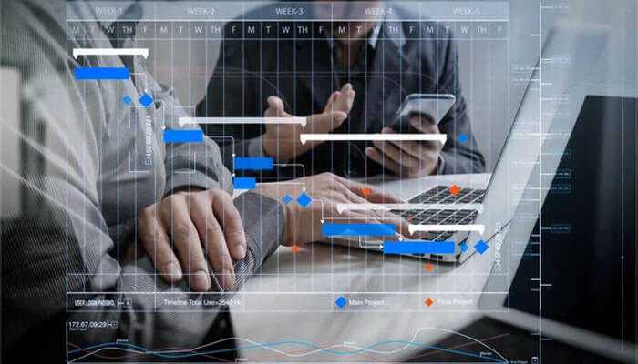 Critical path analysis - tycoonstory | tycoonstory media Team discussing complex project schedules on a digital interface; data analysis and project management highlighted.