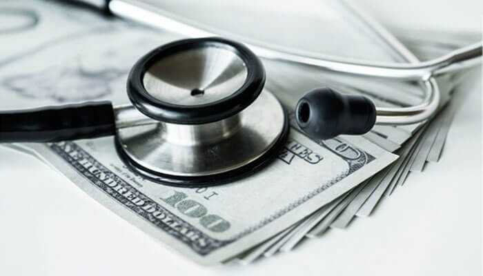 Damages an important element when proving a medical malpractice claim - tycoonstory | tycoonstory media The image shows a stethoscope placed on top of a stack of us 0 bills, symbolizing the financial implications of a medical malpractice claim