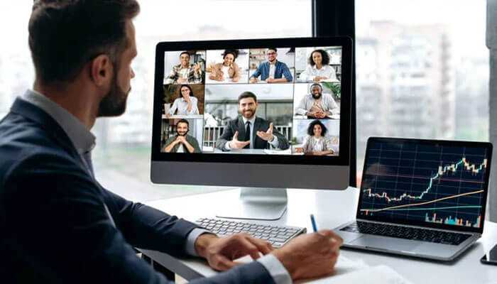 Emerging trends in investment education - tycoonstory | tycoonstory media A professional attending a virtual session by investment education providers while on the laptop analyzing stock trends.