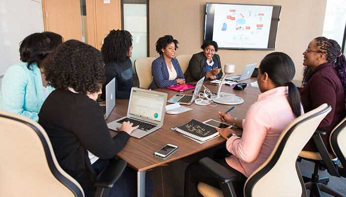 Faster onboarding for new employees Team discussing the benefits of a data catalog in your database for streamlined data management.