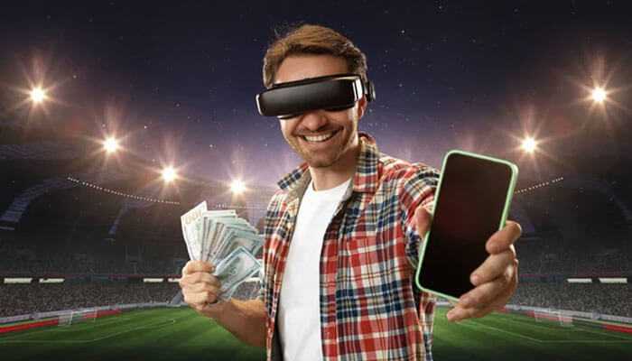 Incorporating new technology - tycoonstory | tycoonstory media A man in a vr headset holding cash and phone in a stadium, symbolizing technology and the creation of sports betting platforms.