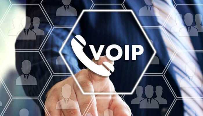Integrating voip with team collaboration software - tycoonstory | tycoonstory media A person pointing at a digital voip icon, representing modern business phone services and communication solutions.