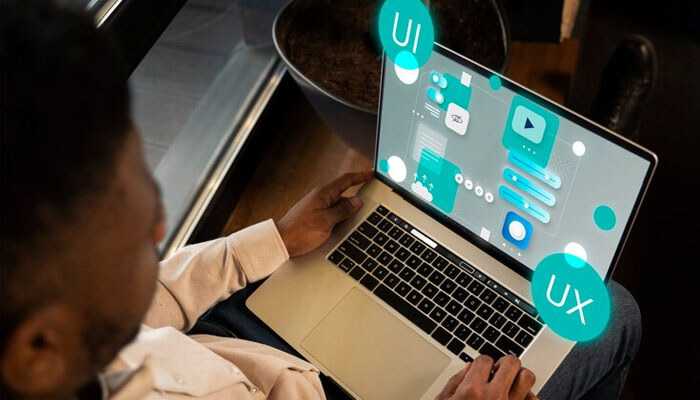 Invest in user experience - tycoonstory | tycoonstory media Scale your software product with a focus on ui/ux design, as a person works on a laptop displaying interface mockups and design elements