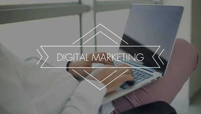 Leverage digital marketing more - tycoonstory | tycoonstory media Person working on a laptop focused on digital marketing strategies for scaling your side hustle