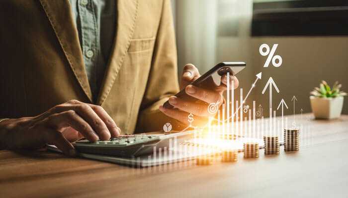 Long-term effects of interest rate changes - tycoonstory | tycoonstory media Businessman was checking phone for long-term effects of interest rate decisions