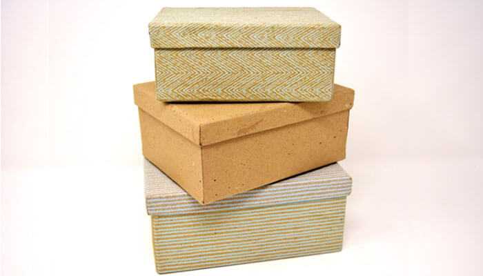 Premium positioning - tycoonstory | tycoonstory media Three eco-friendly packaging boxes with textured patterns, expressing sustainable and minimalist packaging.