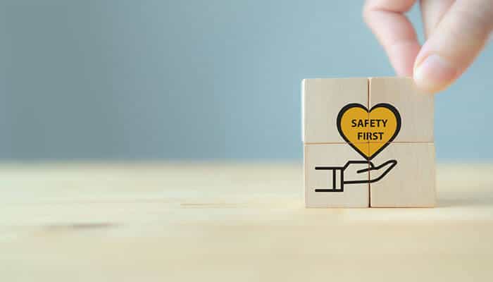 Proper footwear policies - tycoonstory | tycoonstory media To avoid slips and falls in the workplace. The image depicts wooden blocks, one with a heart imprinted "safety first" on a hand, emphasizing safety as a core value.