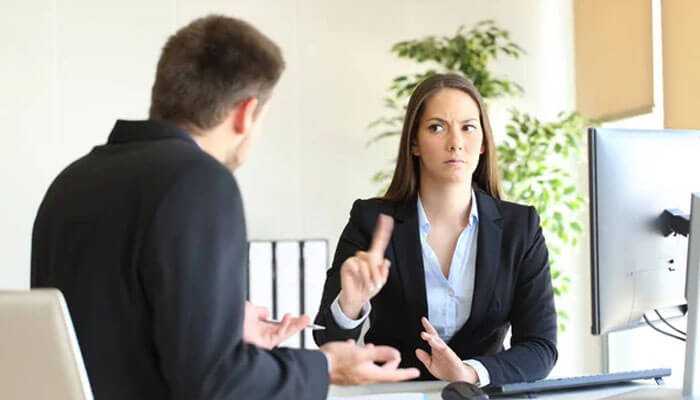 The art of saying no - tycoonstory | tycoonstory media Two people having a tense business conversation; one is gesturing while the other frustrated-maybe discussing scaling up.