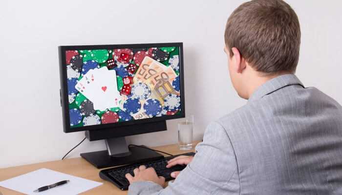The importance of responsible gaming in personalization - tycoonstory | tycoonstory media A man in a suit playing an online casino game on a computer, highlighting the role of personalization in igaming experiences.