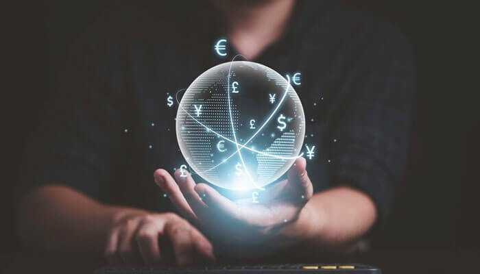 The potential benefits of quantum finance - tycoonstory | tycoonstory media A person holding a glowing sphere with interconnected currency symbols, symbolizing quantum finance and a futuristic global financial network
