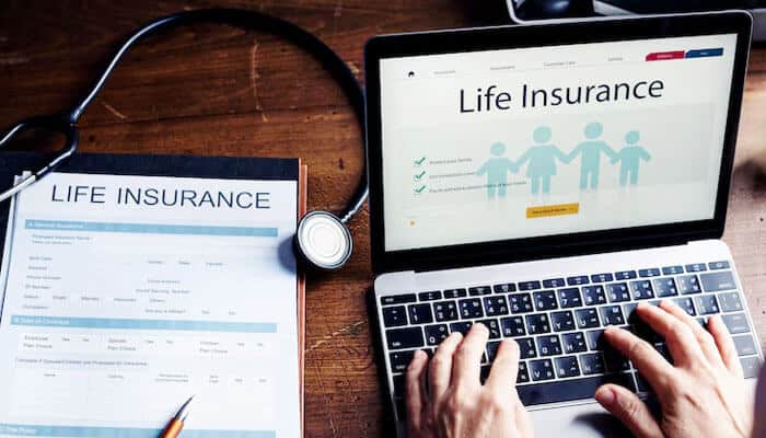 Why professionals choose term life insurance - tycoonstory | tycoonstory media This is an image of a laptop with a life insurance webpage, an insurance form, and a stethoscope, representing insurance management.
