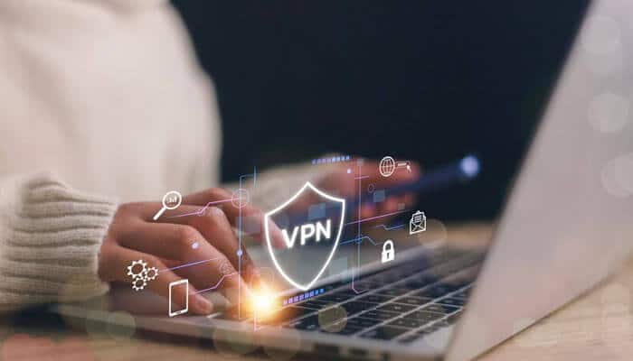 Why vpnly is the best choice for a free vpn - tycoonstory | tycoonstory media Close-up of a person using a laptop with a virtual overlay showing a shield icon labeled free vpn surrounded by security and technology icons, symbolizing online privacy and protection