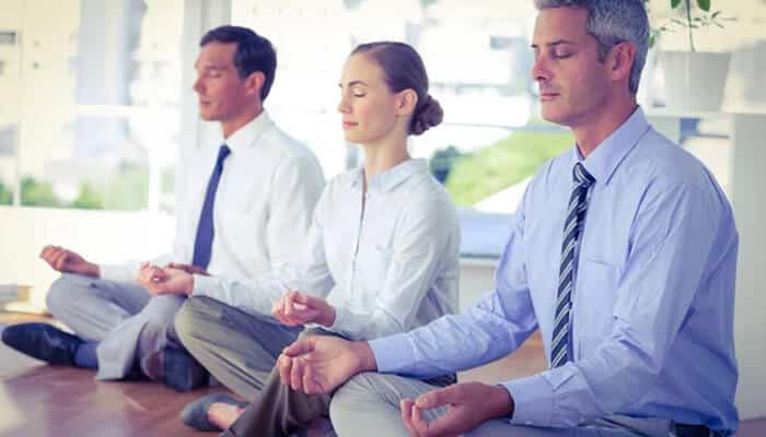 Building of a loyal customer base - tycoonstory | tycoonstory media Business people meditating in the office express a passion for wellness and mindfulness in the workplace.